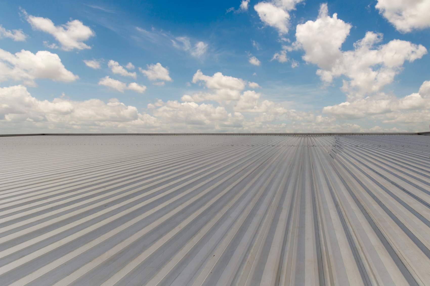 metal sheet roofing on commercial construction with blue sky