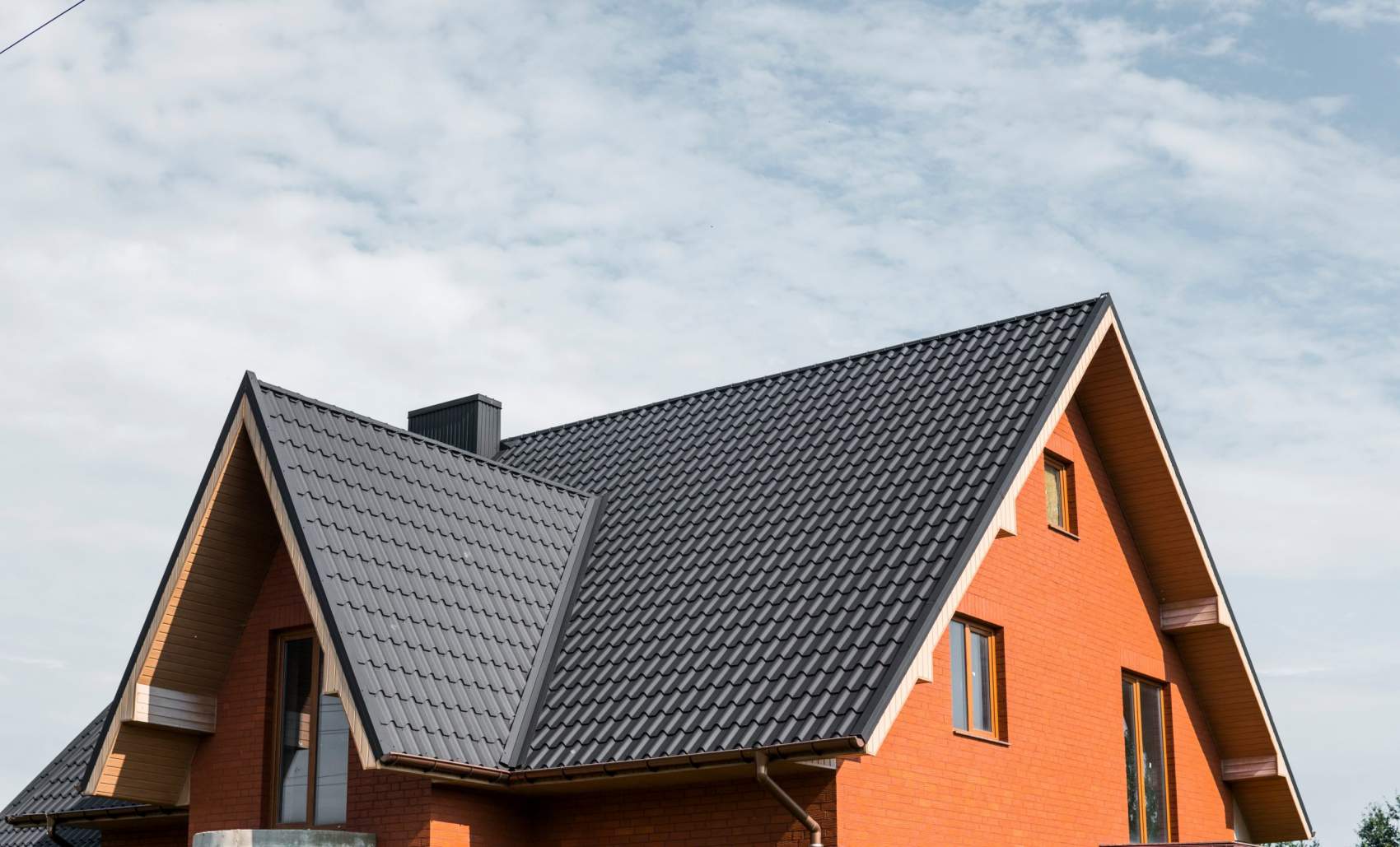 Modern roof covered with tile effect PVC coated brown metal roof sheets