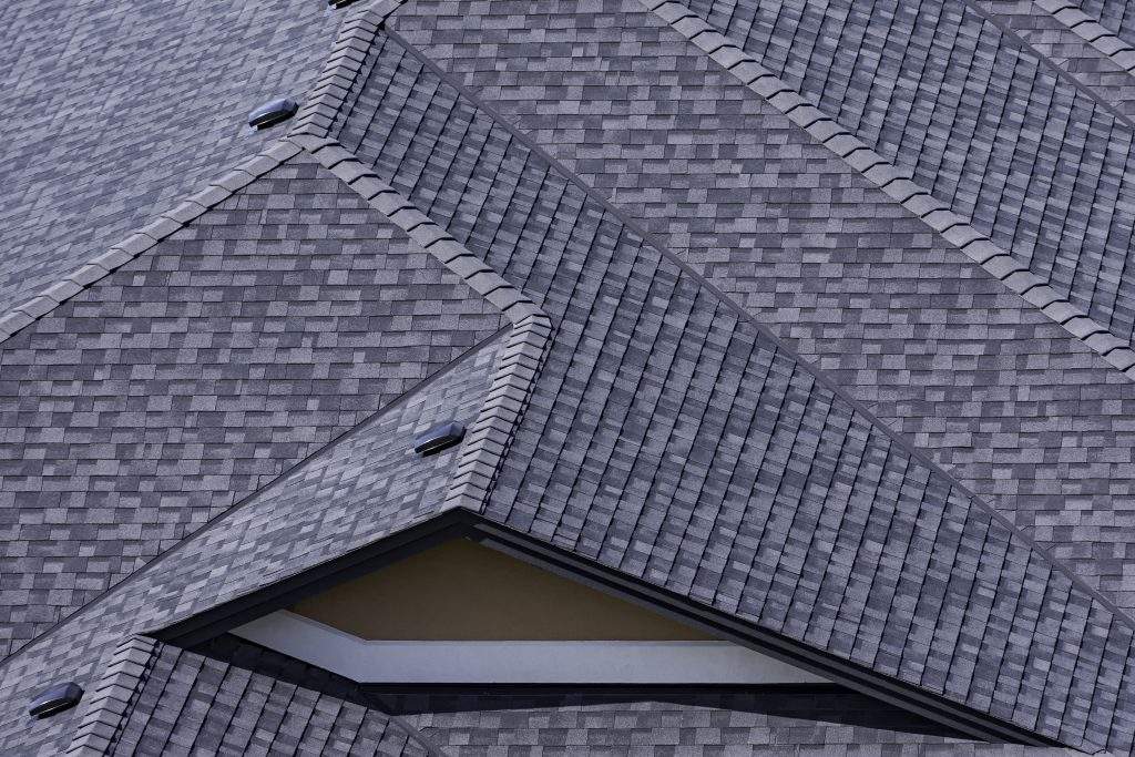 Rooftop in a newly constructed subdivision in Kelowna British Columbia Canada showing asphalt shingles and multiple roof lines