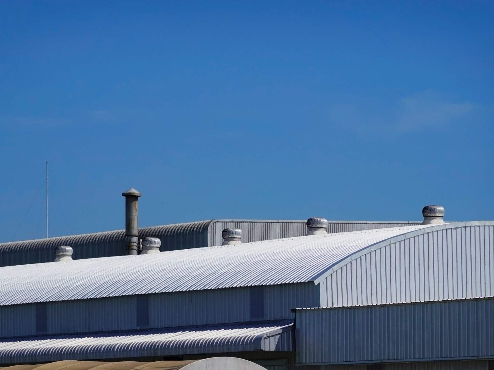 The roof of the factory with the blue sky