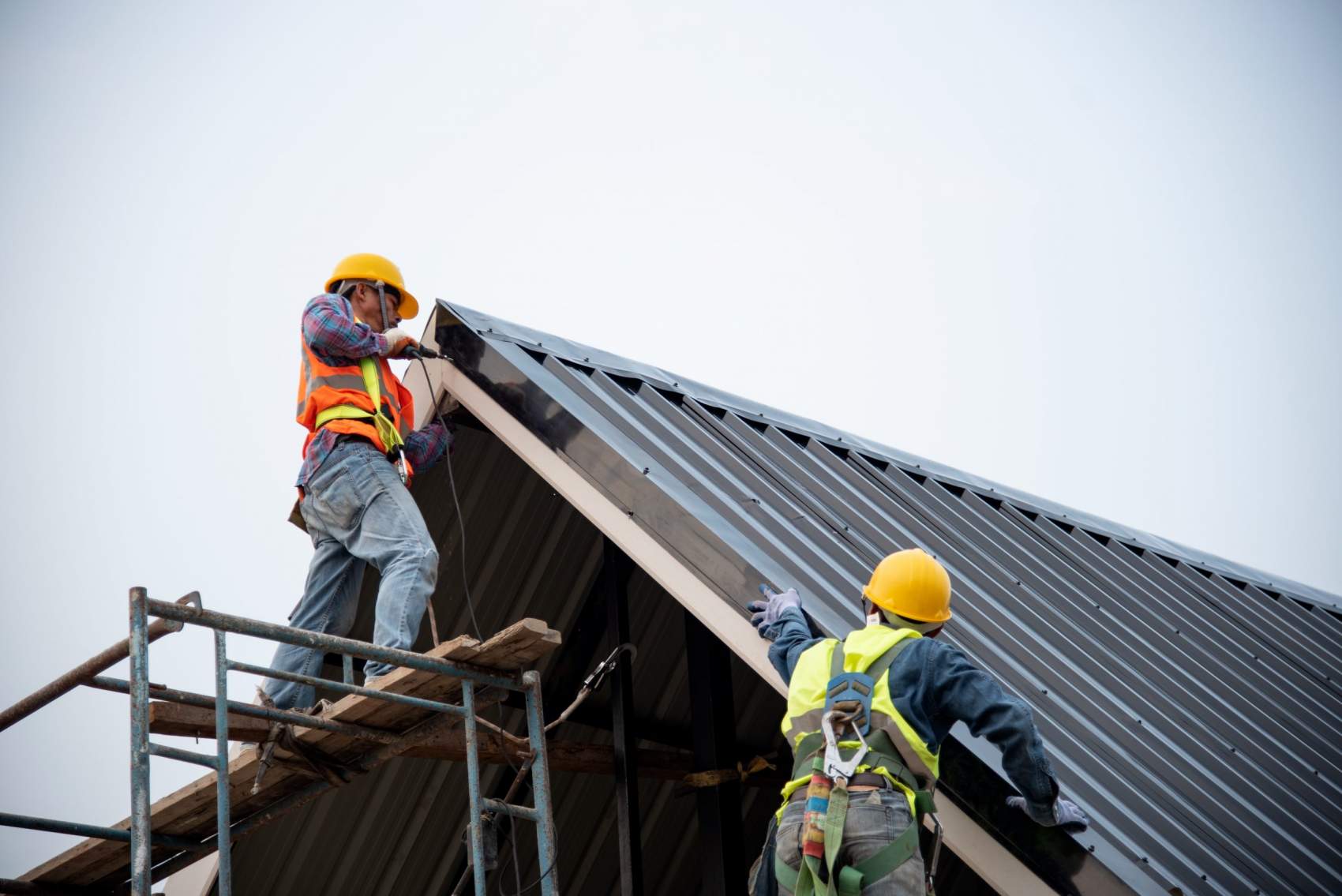 Technician is Work Roof Repair Construction engineer wear safety uniform inspection metal roofing work for roof