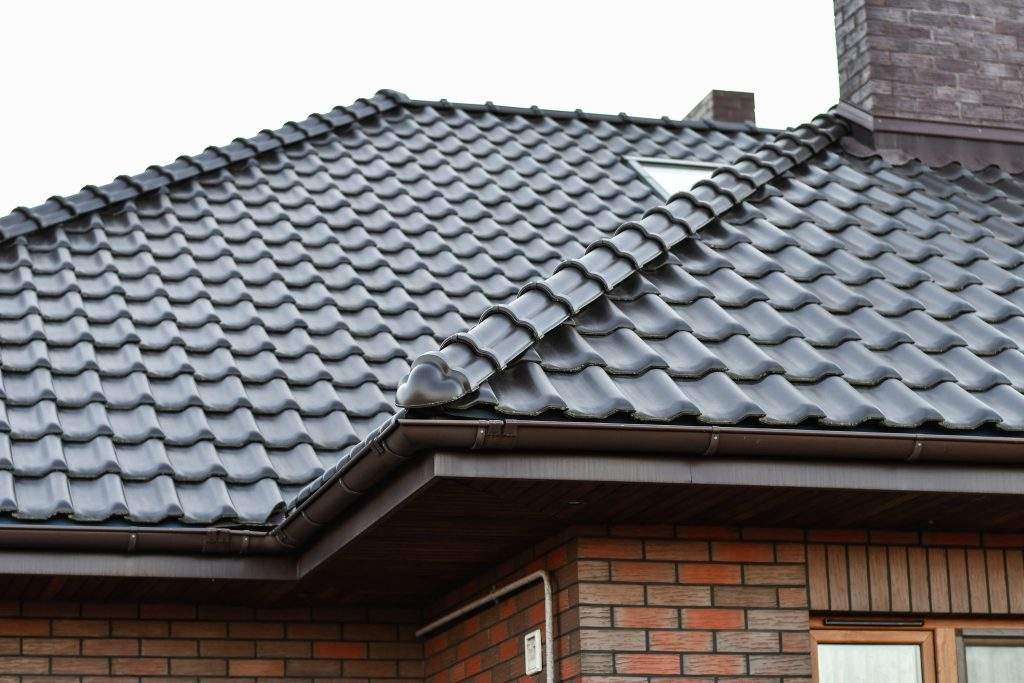Brown ceramic tile roof.  Modern roofing materials. Roof of the